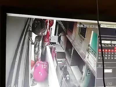 Woman with a Bundle of Cloth on her Head Falls to Death