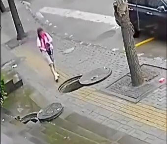 Oblivious Chick Falls into a Sewer