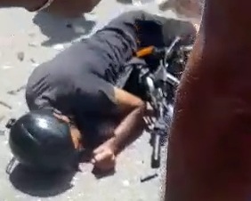 Motorcyclist convulsing after crashing into car