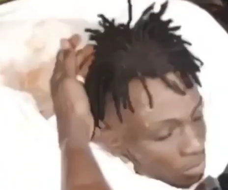 BLACK AXE GANG MEMBER knocking on rival decapitated head 