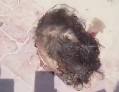 HEARTLESS:Indians stand around a snap photos and selfies of HUMAN HEAD