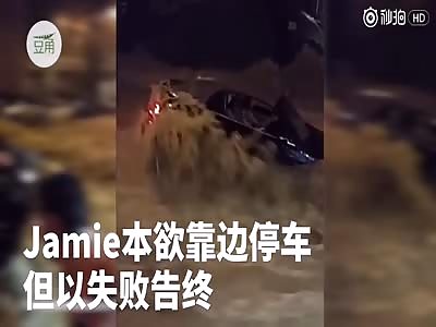 Marineland floods . four traders holding hands to form a human chain to rescue a trapped woman.