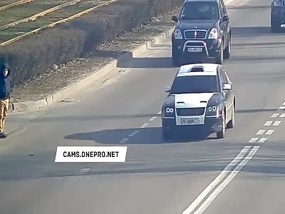 Teenager looks both ways before crossing the street and still darts into traffic 