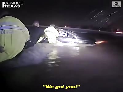 police form a human chain to save a family caught in rushing waters 