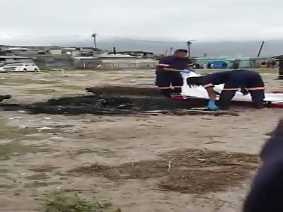 removing the charred remains of people burned alive the night before