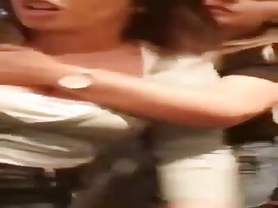 Crazy drunk couple pushing each other, costumers of pub in England 