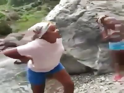 Loud mouth women fighting on the  river bank.