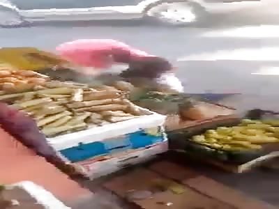Two Mexican women fighting in middle of street 