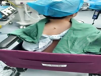 Little Chinese boy with screwdriver stuck in his back 