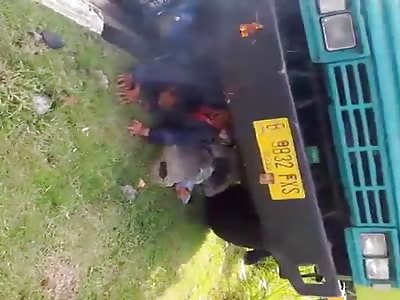 People trapped under the truck and the motorcycle on fire