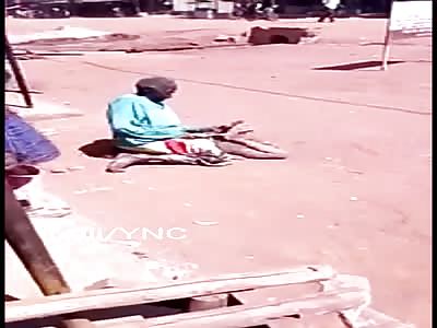 Boy punished with stick by old woman sitting on his face