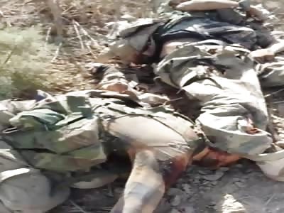 IRAQI SOLDIERS SHOW THEIR FALLEN OPPONENTS