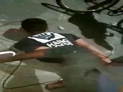 Handcuffed Thief Being Held Down and Caned by Civilians