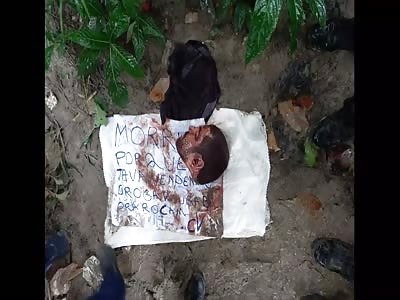 Gang Members Display The Decapitated Head Of A Slain Rival