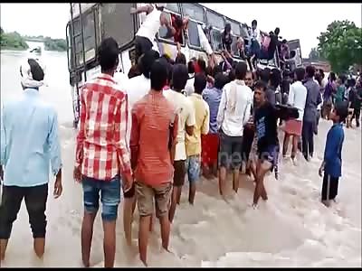 Locals rescue passengers from bus stuck on flooded bridge