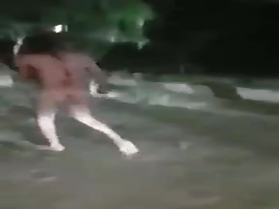 man naked and tied with stick