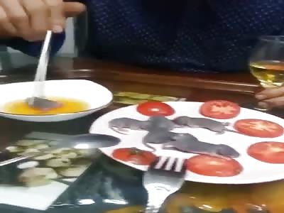 Man eats little rats.