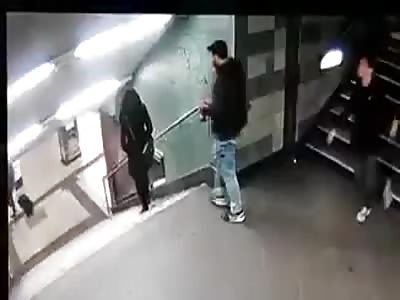 Men's Gang  steps woman down the stairs