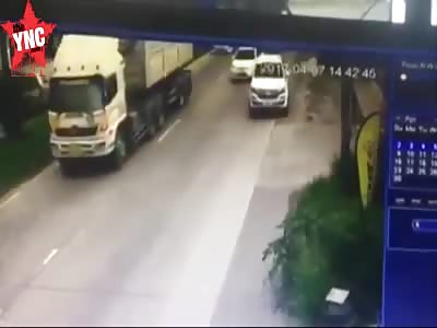 youth falls under a dump truck's wheels and dies