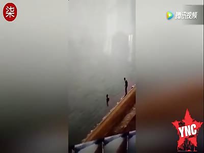 two men just watch and do nothing while two girls  drowned to death right  next to them @0:45 mark