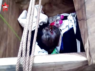 a boy starting to rot is given 2 bottles of water at his funeral  