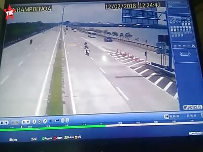 long shot not zoomed in of a Traffic accident  on the toll road benoa bali people on a bike were wedged into tourist bus