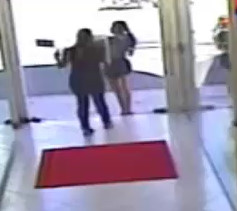 Car Crashes into a Woman Standing at a Store Entrance