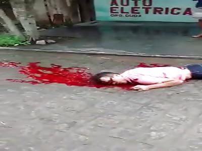 Shot thugs head leaking on the street