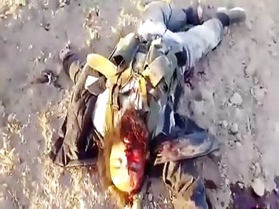 Iraqi soldiers raising the remains of other soldiers with machine after a showdown (part 1)