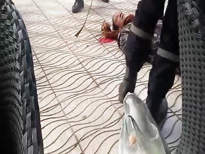 Paramedics lift a wounded man who no longer wants his purchases