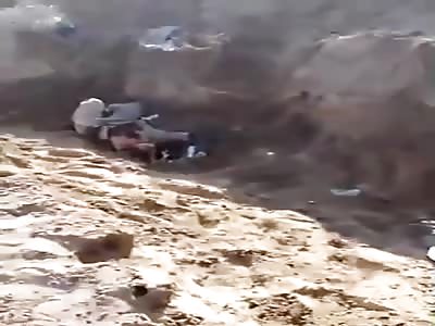 Syrian soldiers show their victim