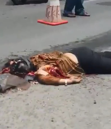 Female Motorcyclist Leaves Behind Long Smear on Road After Collision with Truck