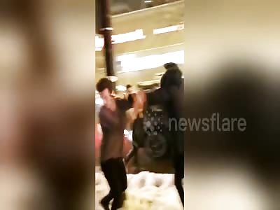 Two Men Fighting In The Snow Outside A Bar In Chicago