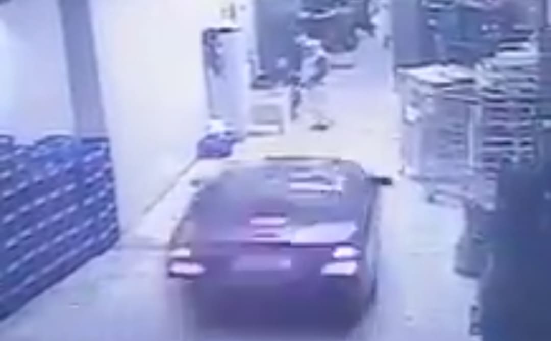 Two Men Meet the Hood of a Car