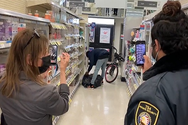 Scared Security Just Films Guy Looting Store on his Bike