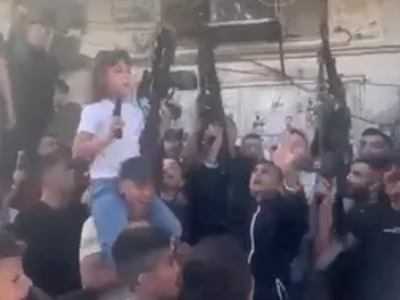 10 Year Old Girl Ak-47 in one hand, Pistol in the other. Hamas Celebrates Occupation of Israel