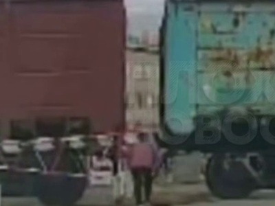 A train crushed a woman who was trying to walk between the cars