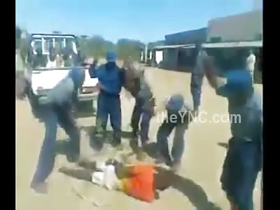 Several Police Officers Beat Tied Suspect with Sticks For Apparent Fun