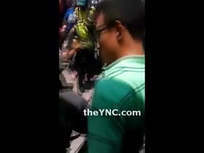 Police Trying to Arrest a Man but Can't Get to Him because the Crowd is Beating on Him too Much 