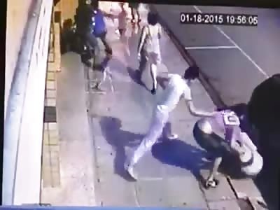 All out Gang Brawl in the Middle of the Day on a Busy Street