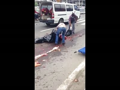 Cleaners Collect Victim's Pieces While People Films and Laugh