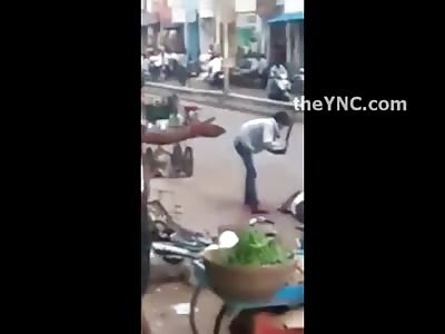 Madman in the Street Stands Over his Kill and Continues to Hack with a Machete 