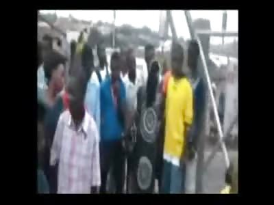 African Girl in Nice Clothes Killed Herself by Hanging from a Chain Link Fence