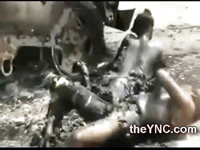 Yemeni Soldiers Burned to Death lie on the Road next to Armored Vehicle