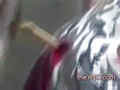 Tough Guy in Camo Shirt hanging out in Crowd with a Knife in his Back