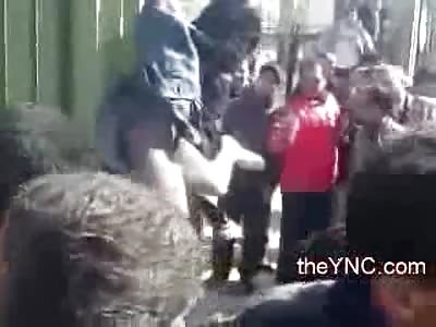 Man Lynched Hanged Upside Down on a Wall as Excited Crowd gets Rowdy