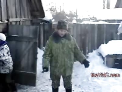 We Gotta Eat, Man uses Ax to Kll his Dinner as the Dog licks the Cold Blood off the Snow