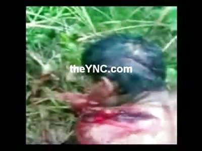 Let him Die...Man Mutilated from a Machete Squirms in the Dirt as Soldiers watch him die