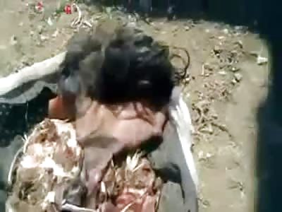 Playing with the Scalped Head of His Victim