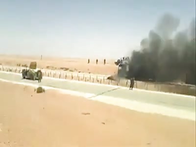 Bizarre video of Two Men Hanging Dead in Front of Burning Building as Soldiers Record with Cell Phones